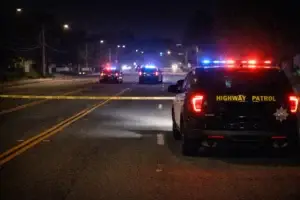 California Highway Patrol vehicles block Winter Gardens Boulevard at night during a fatal motorcycle crash investigation in Lakeside.